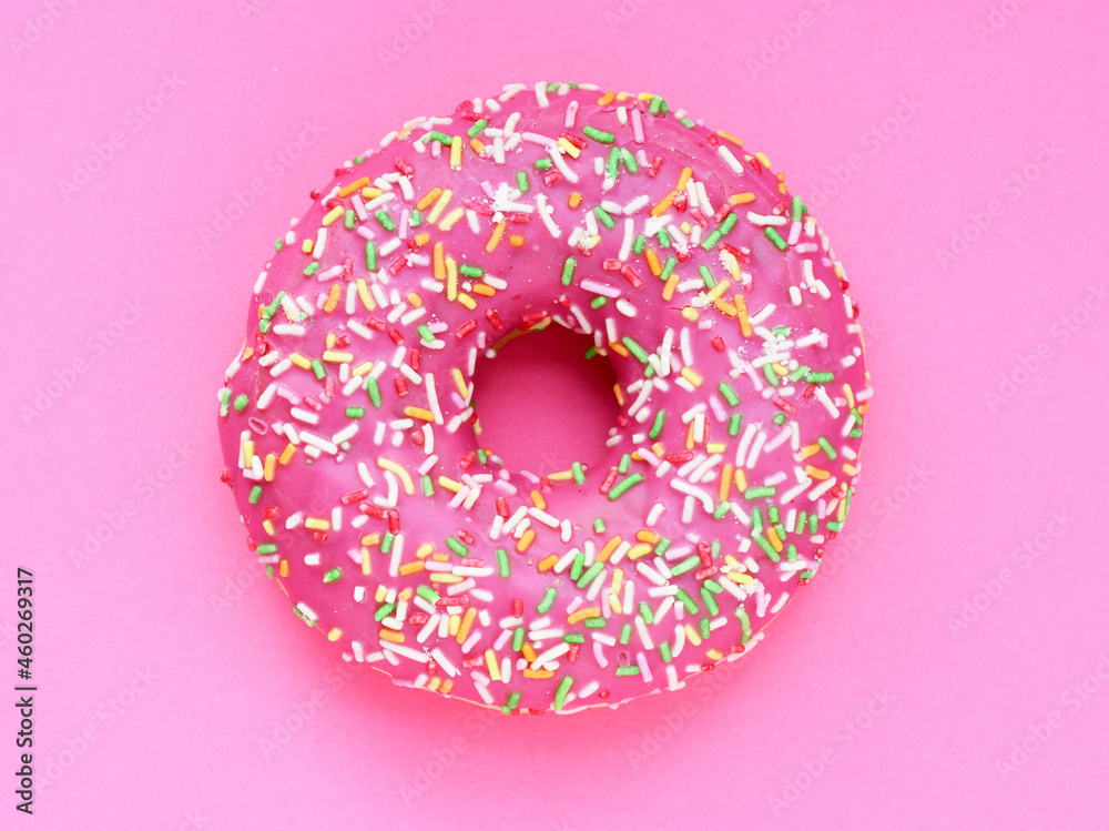 Donut with a pink icing on a pink background - obrazy, fototapety, plakaty 
