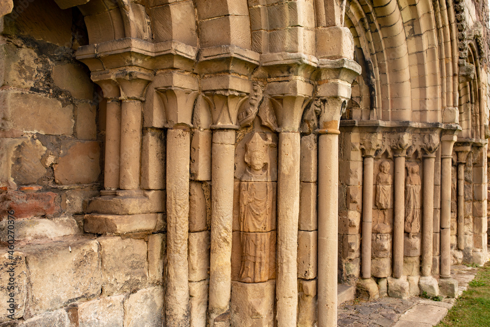 Stone columns and figures carved on a medieval abbey ruin.  Medieval architecture concept