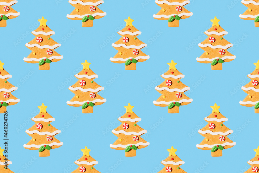 Obraz premium Seamless New Year's pattern from Christmas tree toy in form of spruce tree made of cookies on blue background