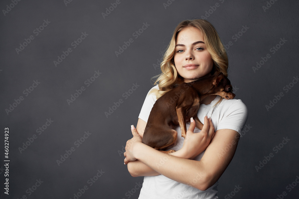 Fototapeta premium woman with a small dog makeup posing dark background