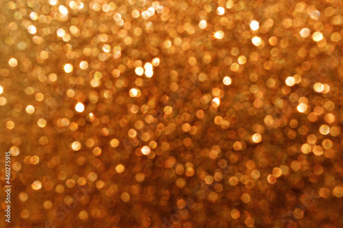 Brown bokeh shiny light sparkle glitter background. Photo can be used for Christmas, New Year and all celebration backgrounds.