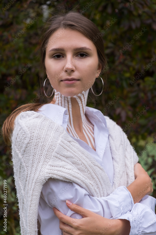 Face and body taping. A special cosmetic procedure for the skin. Beautiful young girl in autumn on the nature Face and body taping. A special cosmetic procedure for the skin. Beautiful young girl in autumn on the nature