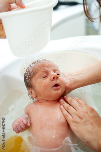 First bath of newborn baby boy.