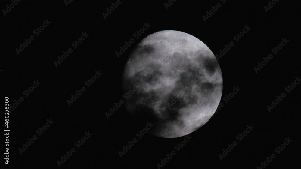 Close-up Telephoto Shot Of A Full Moon Hiding Behind Dark Clouds. Real Time. Spooky Halloween Night Scene. Location: Sweden, Scandinavia. Close-up Telephoto Shot Of A Full Moon Hiding Behind Dark Clouds. Real Time. Spooky Halloween Night Scene. Location: Sweden, Scandinavia.