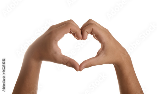 Teenage boy showing heart with hands on white background  closeup