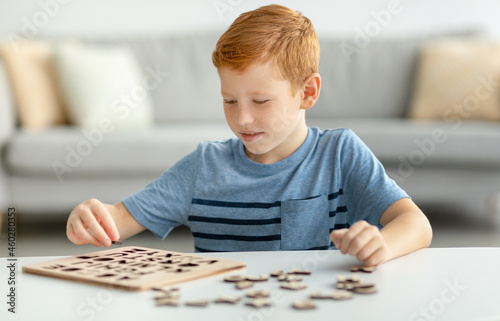 Kid playing with educational game, collacting letters