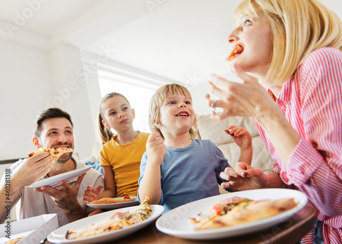 pizza family child food home eating son daughter mother father happy meal together lunch dinner man woman boy girl fun