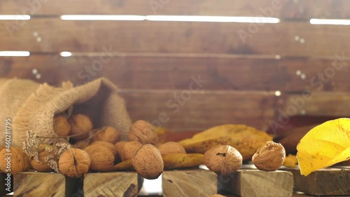 canvas bag with walnuts on wooden background, autumn harvest concept, healthy food, thanksgiving and fall background.  photo