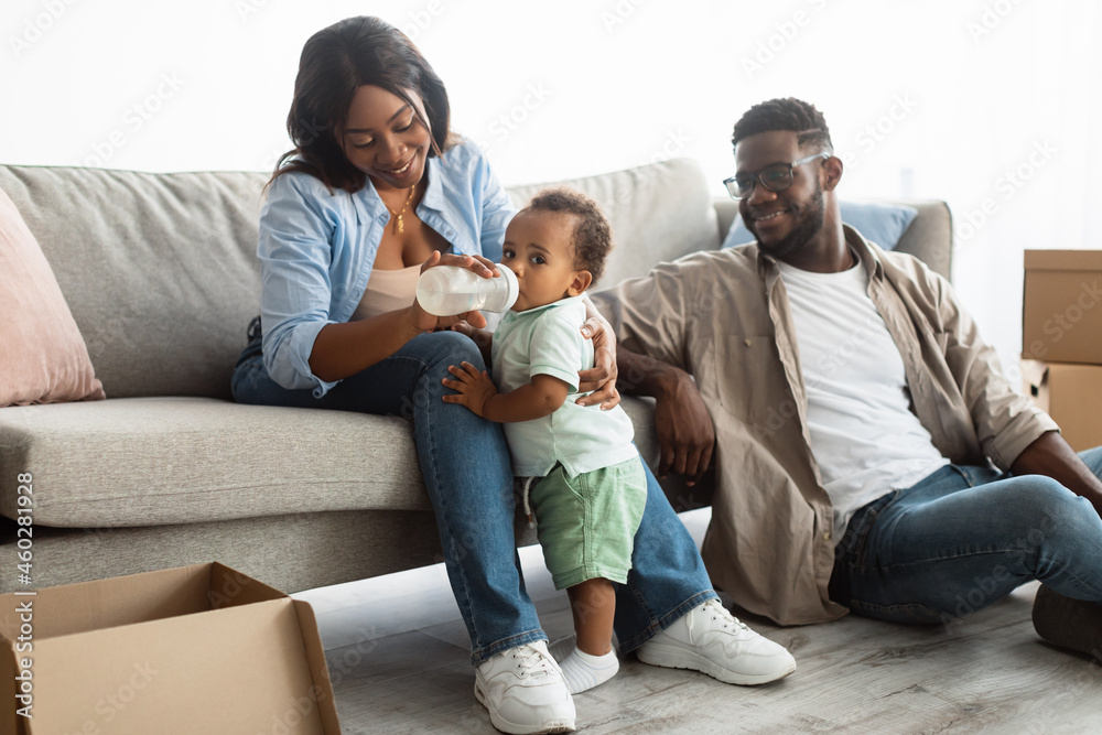 Happy African American family moving in new apartment Happy African American family moving in new apartment