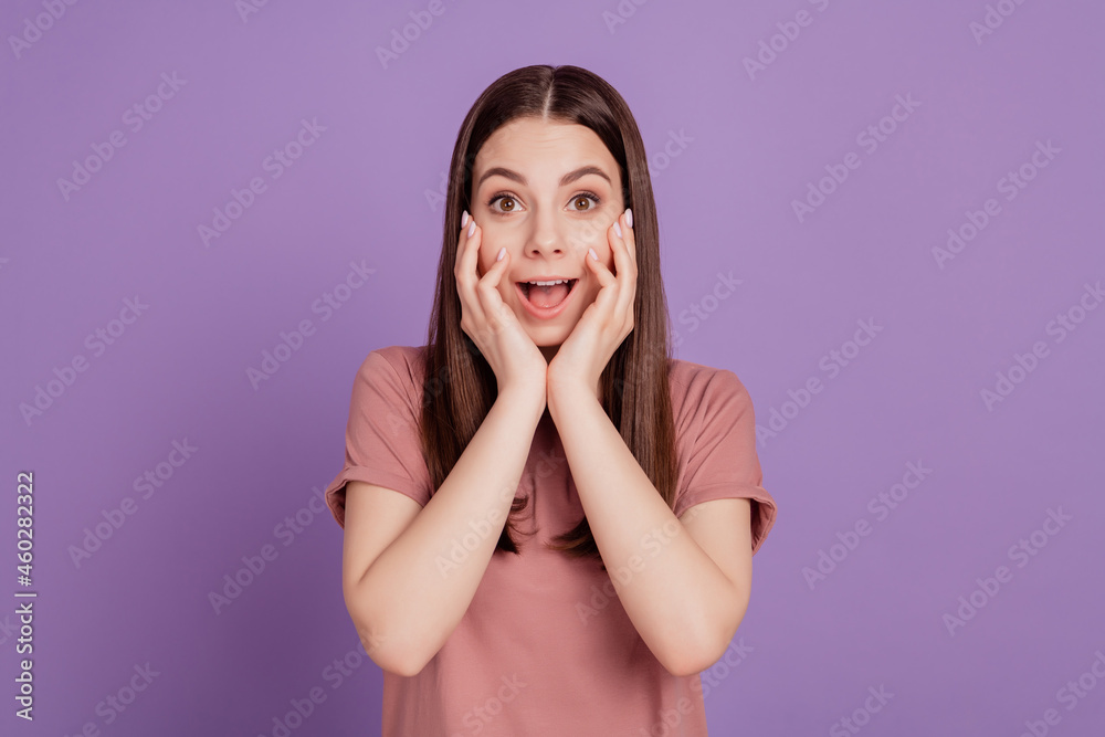 Photo of excited surprised girl hold hands face scream isolated over purple background Photo of excited surprised girl hold hands face scream isolated over purple background