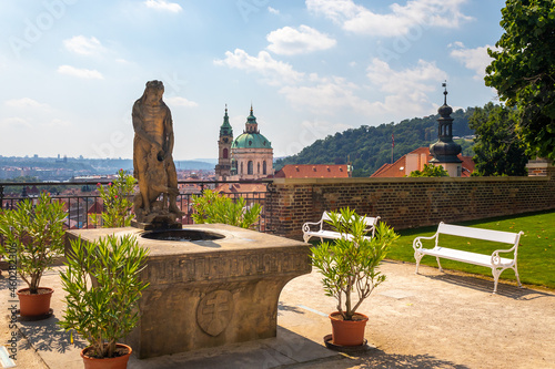 fountain with statue of Hercules in the garden, Prague Castle, view of the Church of St Nicholas, Czech republic photo