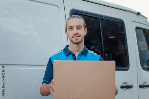 young delivery boy holding box