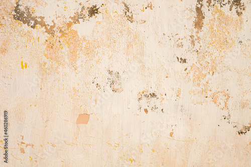 The old cement wall, painted and putty, peels off and collapses. Grunge background texture © yanik88