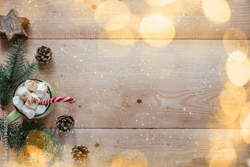 Christmas background with marshmallow hot chocolote, fir tree branches, and Christmas lights photo