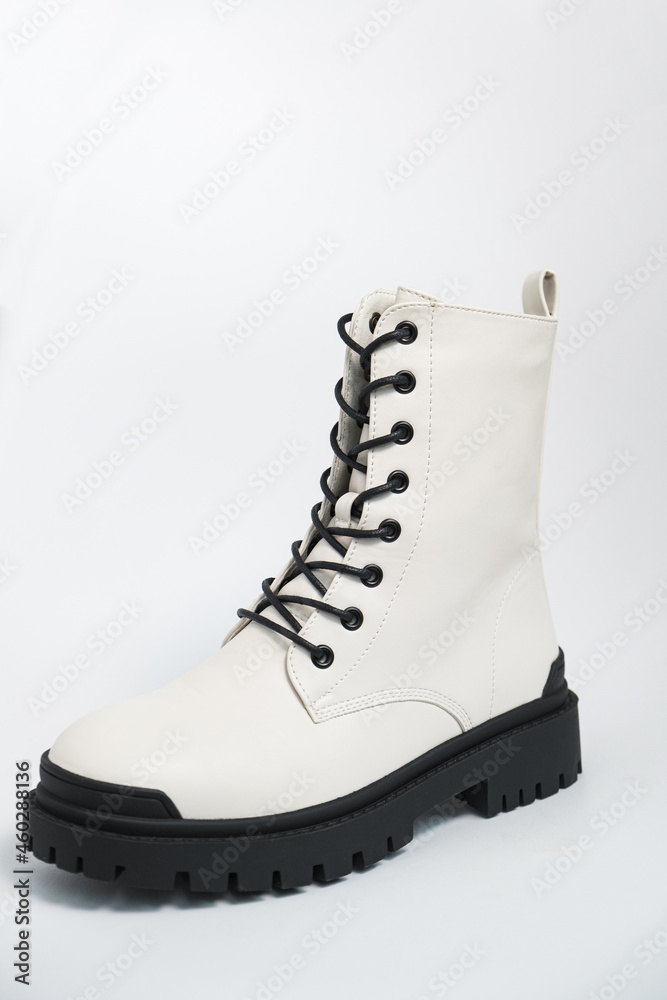 White womens autumn rough army boots on a tractor sole with laces, on white background White womens autumn rough army boots on a tractor sole with laces, on white background