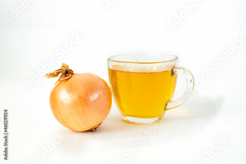 onion and a transparent cup of tea, isolated on white 