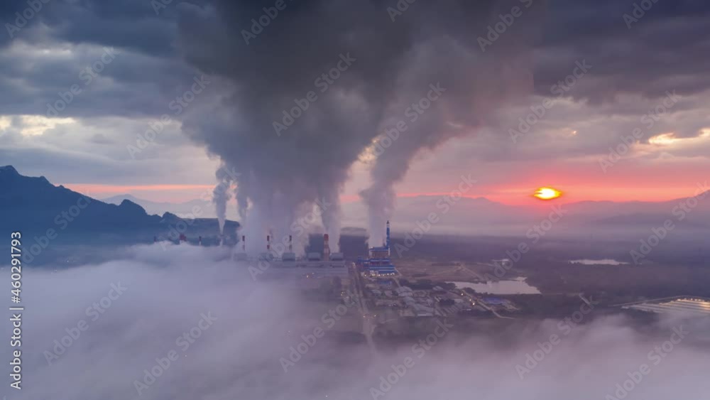 Hyper lapse, Beautiful Landscape in the morning time with fog and background Mae moh coal power plant Lampang, Thailand. The industrial white steam from cooling tower pipes, concept environment.