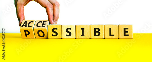 Possible and accessible symbol. Businessman turns wooden cubes and changes the word possible to accessible. Business and possible or accessible concept. Beautiful white background, copy space. photo