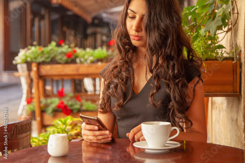 Young beautiful woman with smartphone as symbol of social Media addiction. Psychological problems and media mania concept.