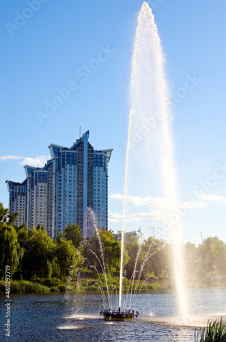 Autumn landscape of fountain in the city channel near Rusanovka neighborhood at sunny day. New high-rise fashionable houses. Concept of modern architecture from glass, steel and concrete