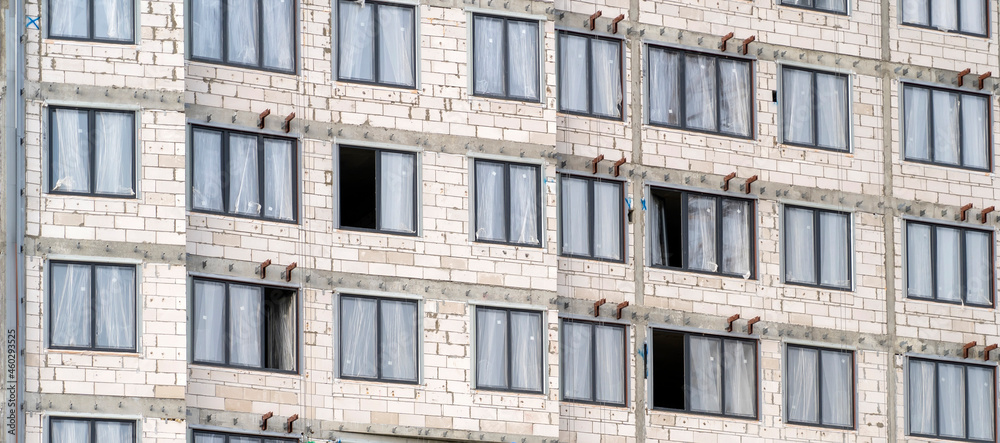 Windows and walls on construction site of multi storey building texture. Modern civil engineering. Buildings industry. Urban construction. Unfinished building. Concrete structures. Windows and walls on construction site of multi storey building texture. Modern civil engineering. Buildings industry. Urban construction. Unfinished building. Concrete structures.