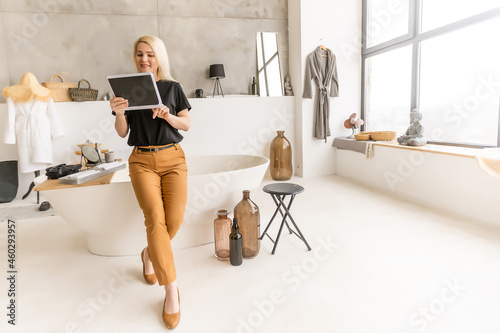 woman laughing and chatting through her tablet