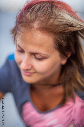 Young blonde happy girl resting in the park on a warm summer day photo