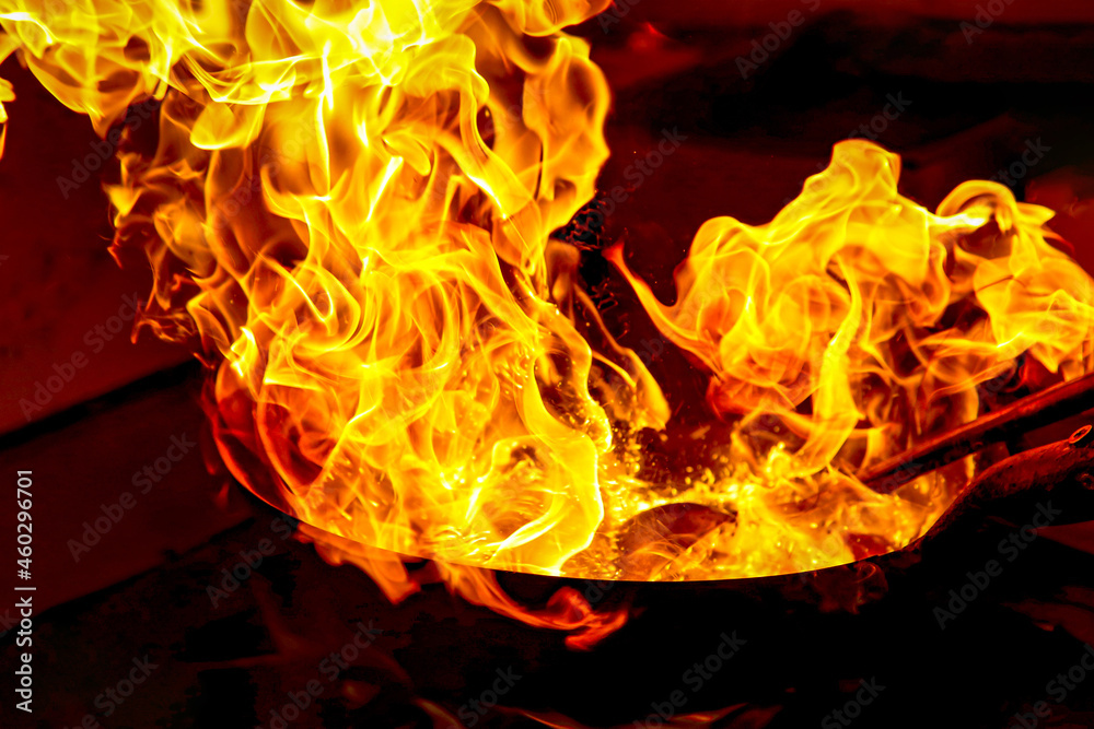 Oil catches fire while cooking and sparks are visible ภาพถ่ายสต็อก