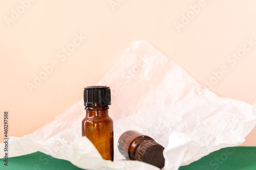 Aroma oil glass bottle with torn paper, skin care products photo