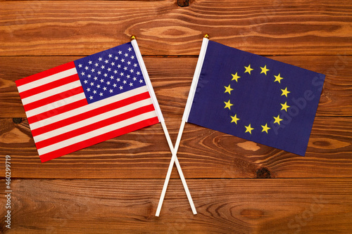 Flag of USA and flag of European Union crossed with each other. USA vs Europe EU. The image illustrates the relationship between countries. Photography for video news on TV and articles