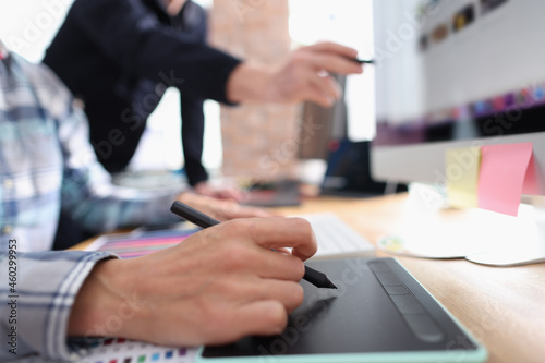 Two graphic designers working in office closeup