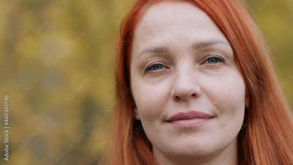 portrait of a life style woman with red hair in autumn against a background of colorful foliage portrait of a life style woman with red hair in autumn against a background of colorful foliage