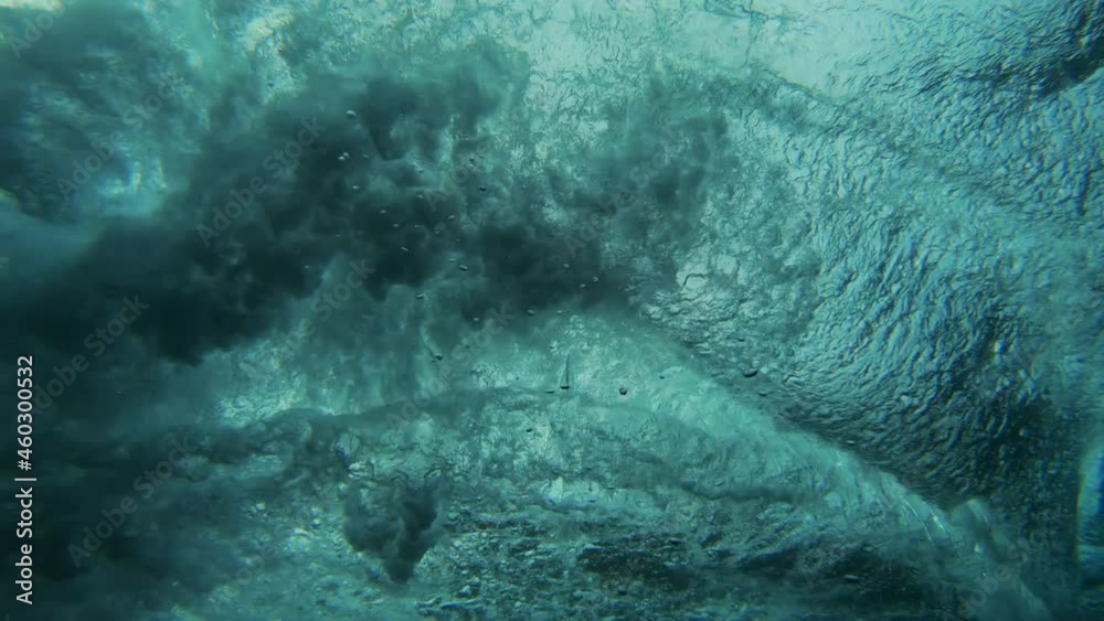 Underwater view of young man surfing in South Male Atoll