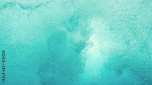 Underwater view of young man surfing in South Male Atoll