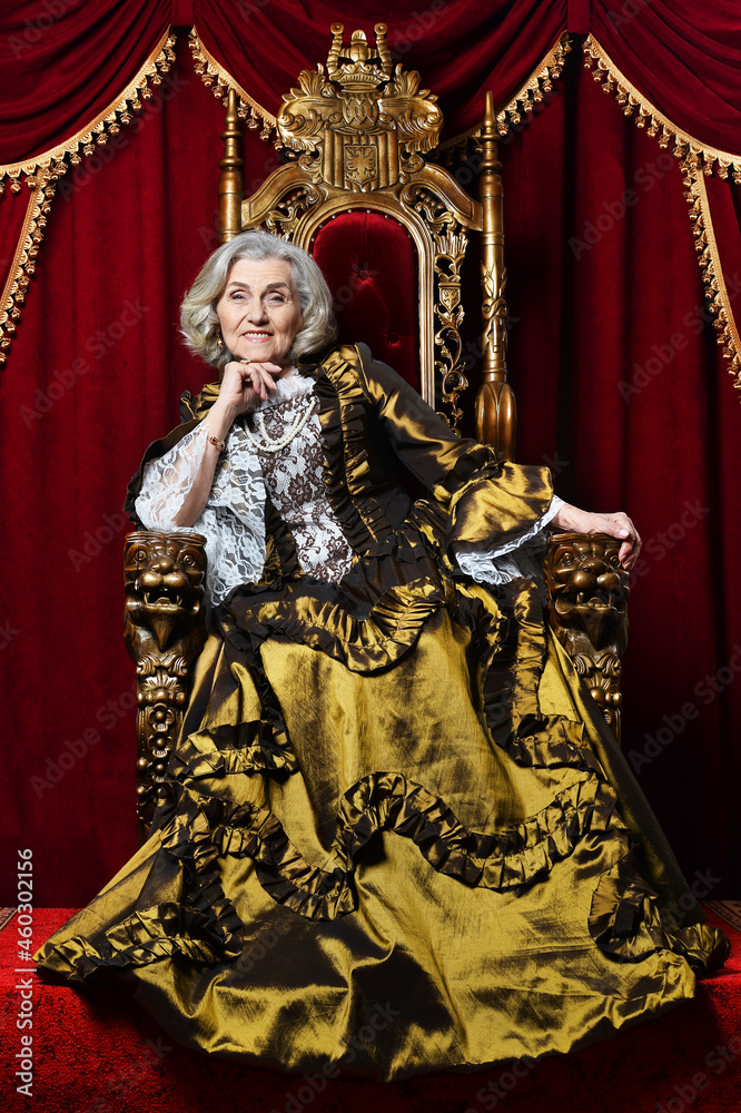 Portrait of beautiful senior queen on throne