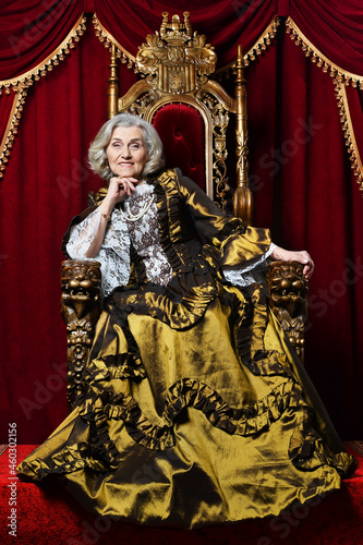 Portrait of beautiful senior queen on throne