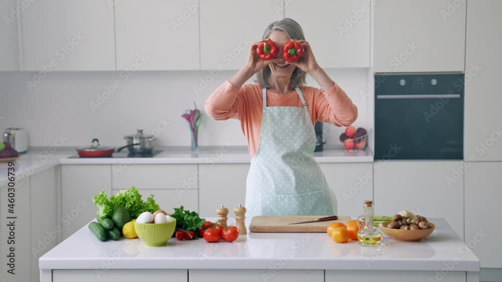 Cheerful positive cooker lady hold paprika close eyes Cheerful positive cooker lady hold paprika close eyes