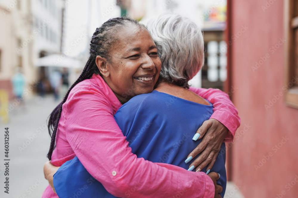Fototapeta premium Elderly multiracial women hugging each other - Friendship, love and senior people concept