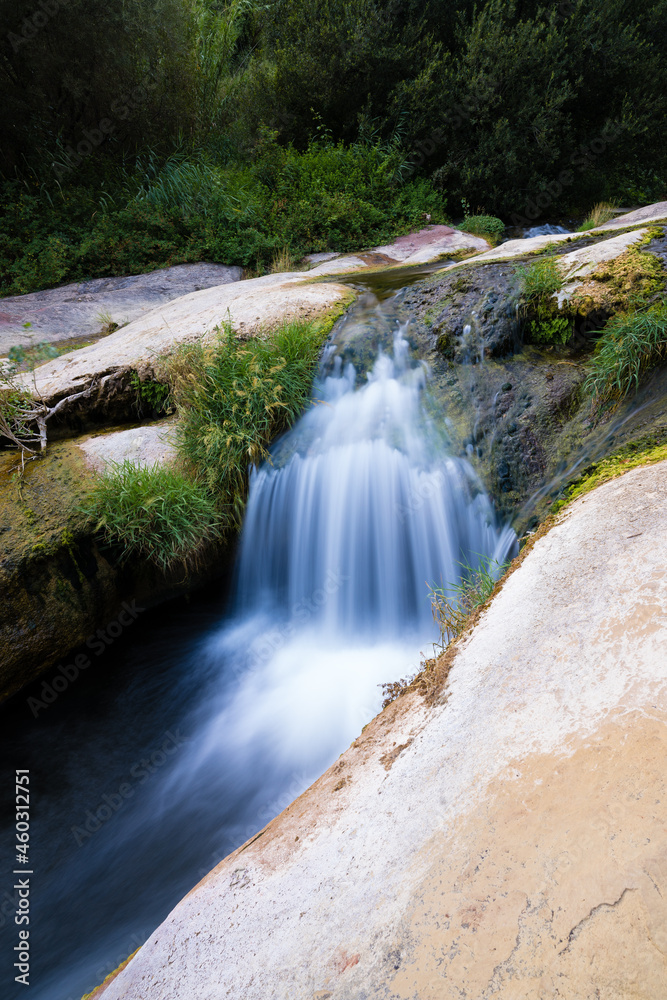 Fototapeta premium waterfall between white rocks, natural pools and moss, sant miquel del fai catalonia, spain