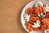 Delicious ginger cookies of different shapes for Halloween on a brown surface. Close-up. Copy space.