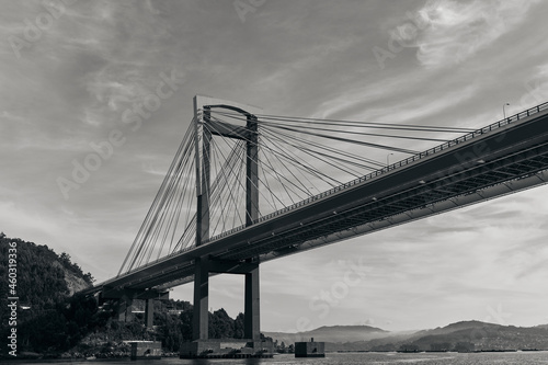Bridge of Rande in Vigo, Spain, black and white image taken from a boat on the sea #460319336