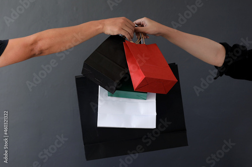 Canvas Print Crop of hand holding shopping bag or goodie bag for shopaholic or online shoppin