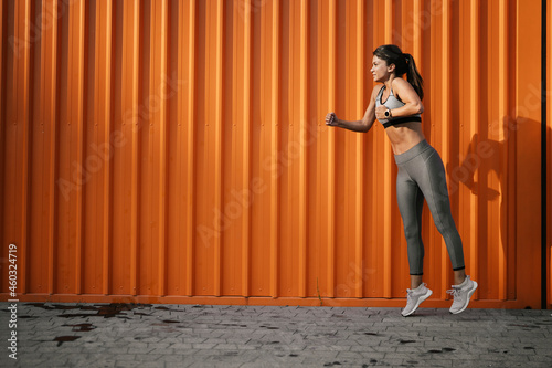 Beautiful athlete woman in sportswear. Young woman training outdoors © JustLife