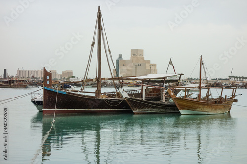 Traditional Arabic Dhows on the sea with city skyline behind