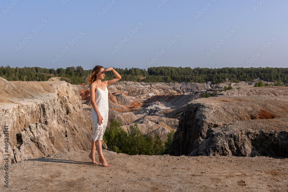 A beautiful woman on the background of landscape.Top view of the quarry.