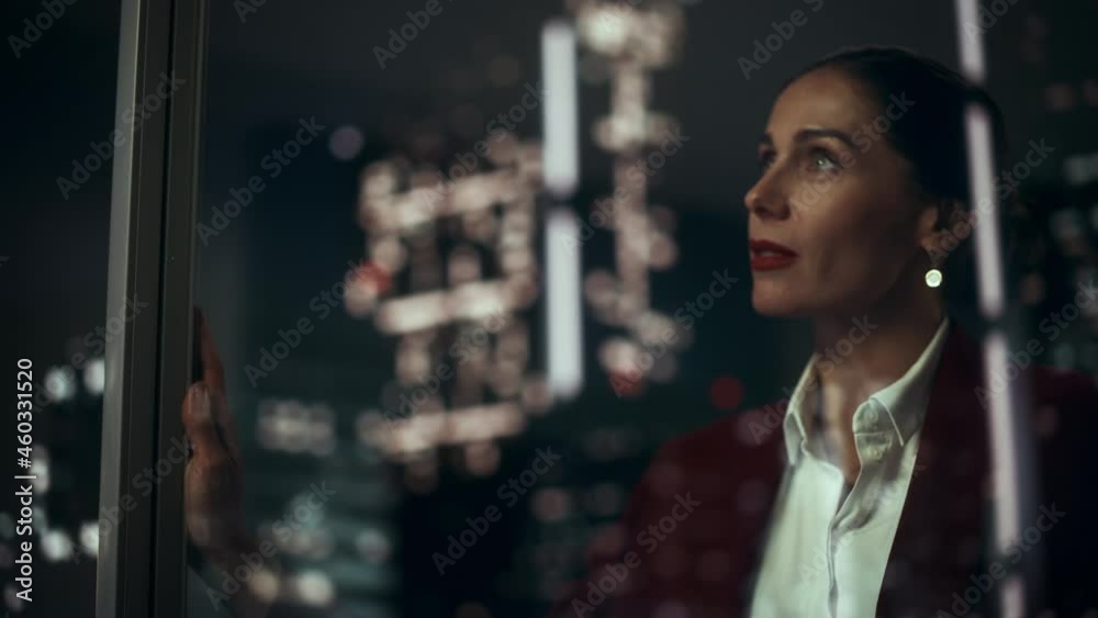 Successful Businesswoman in Stylish Suit Working, Looking in Wonder at Night City. Stylish Female CEO Working Late and Hard to Create e-Commerce Online Shopping Experience Sustainable and Safe