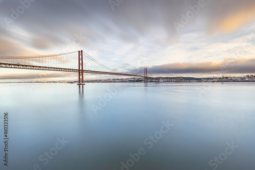 the 25 de Abril suspension bridge over Tagus river in Lisbon, Portugal at sunrise photo