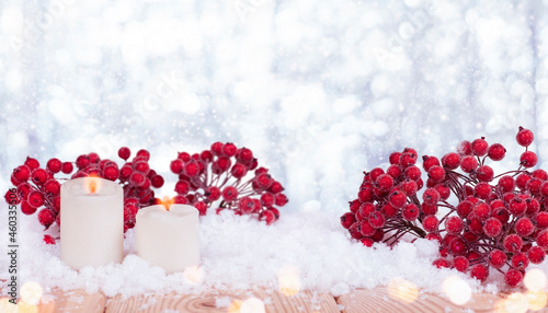 christmas background with candles and red  rowan in the snow