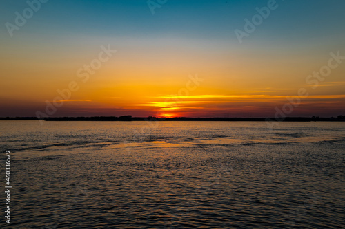 Still waters of the Amur river at sunset in late September in Khabarovsk, Russia. 