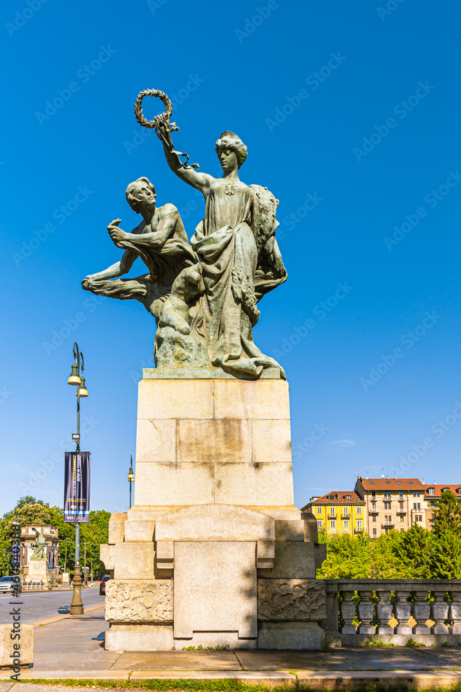 Turin, Italy, May 12th, 2021. Bronze statue representing the Majesty who protects the Art located near the ancient Umberto I Bridge, Corso Moncalieri side.